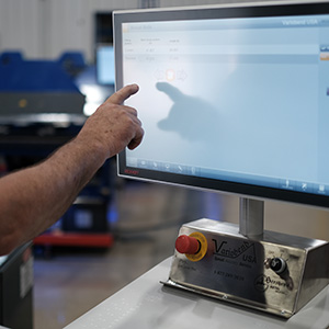 Machine technician pointing to screen